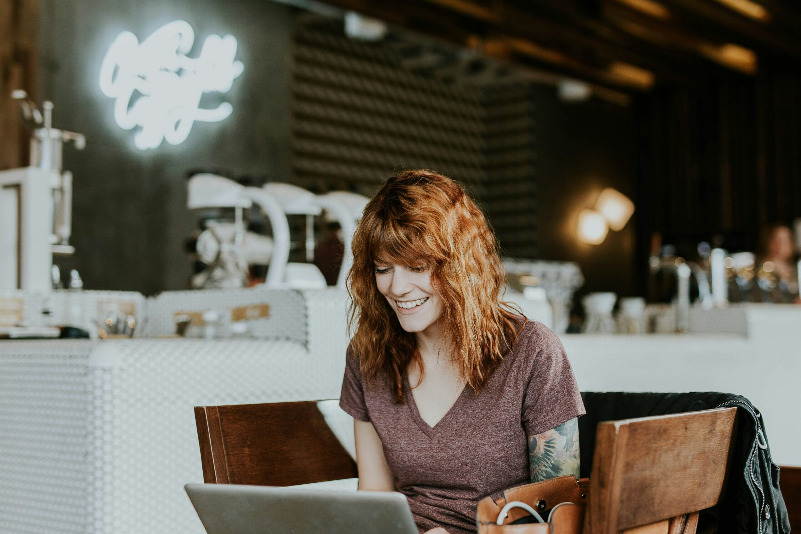 Woman working hybrid in a coffee shop